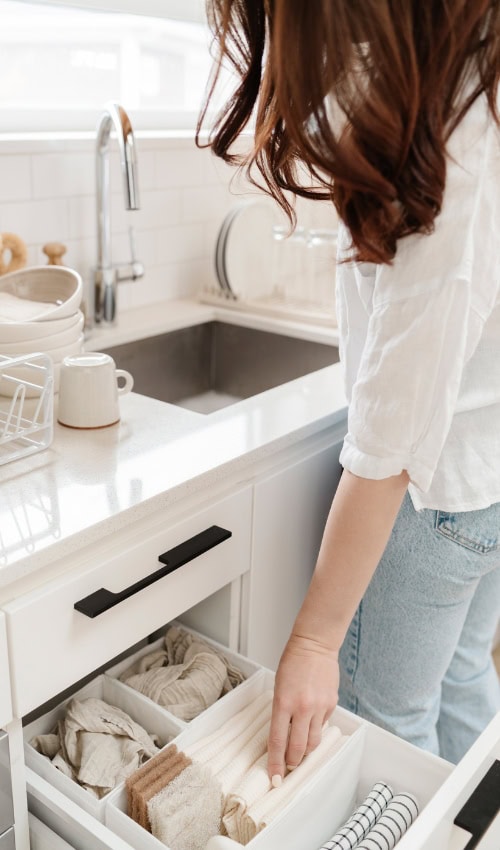 woman opens a drawer of cleaning supplies Cleaning Aesthetic ideas