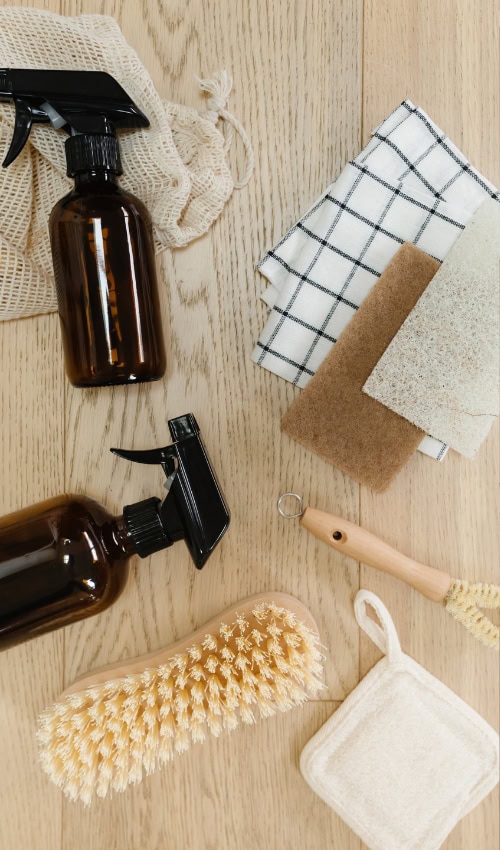 cleaning supplies beside a deep cleaning house checklist