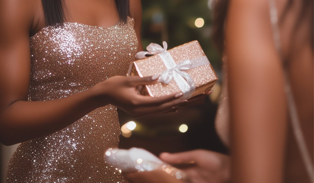 woman hands hostess a gift at dinner party after learning about the best classy hostess gift ideas