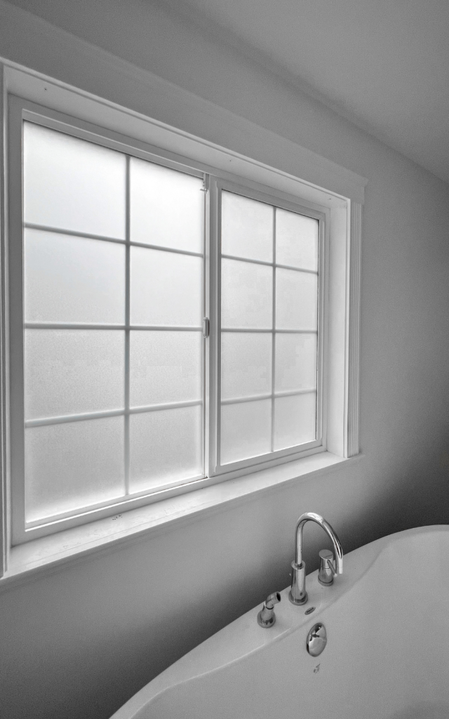 detail of the results of applying privacy window film to bathroom windows to make windows opaque and private