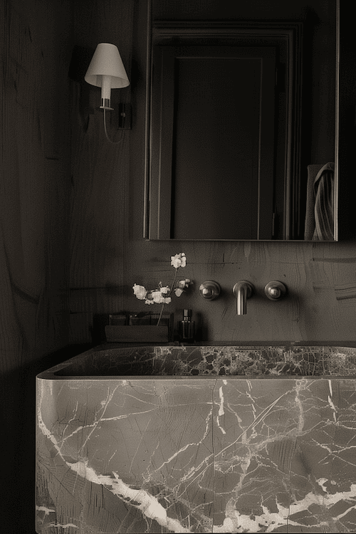 bathroom Lighting in black bathroom with marble sink