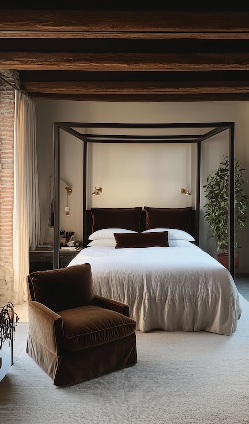 black four poster bed with white bedding and velvet burgundy accent pillow creates a moody bedroom aesthetic perfect for Fall