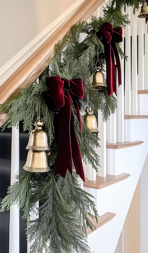 red velvet bow on stairs garland showing How to hang garland