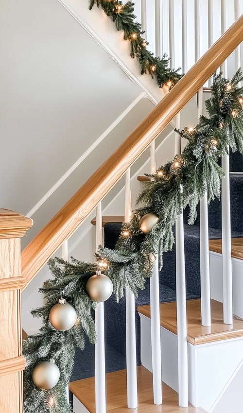 ornaments on a cottage christmas garland stair railing